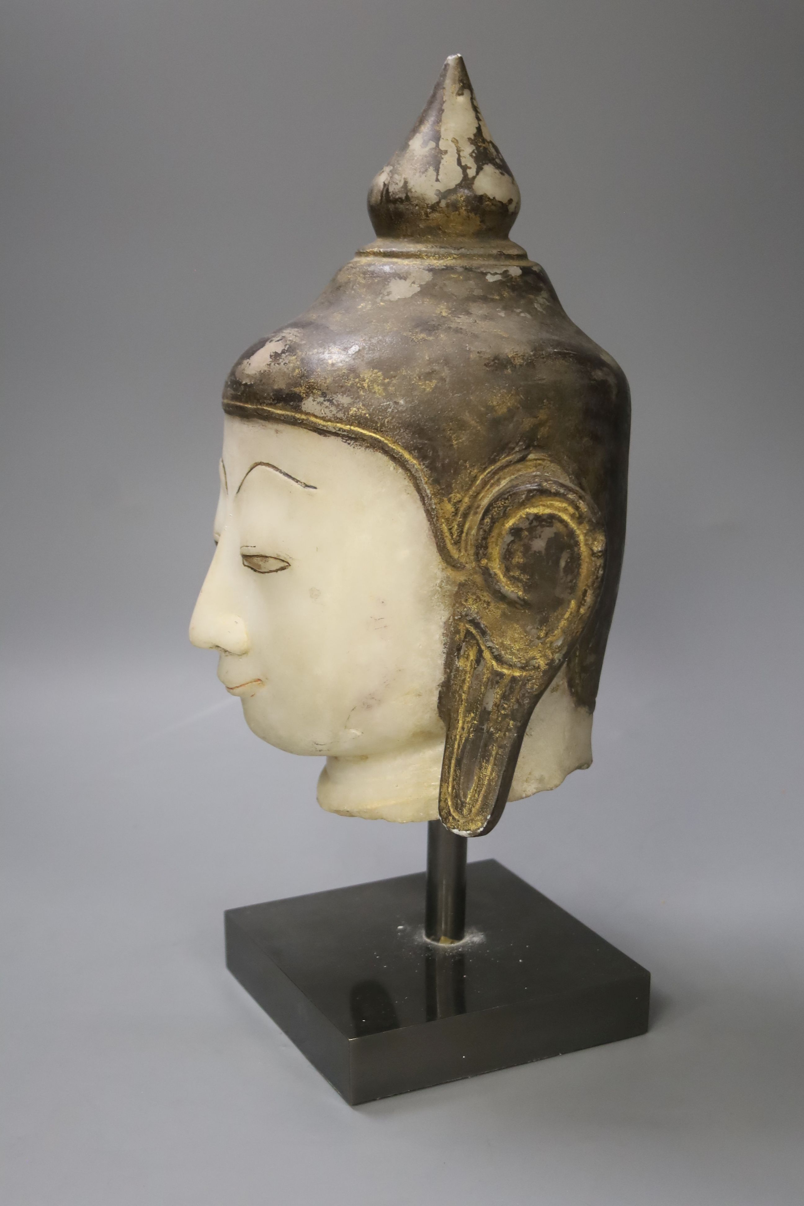 An 18th century Burmese white marble Shan-Style Buddha’s head, on stand, bought in 1995 in Burma or Myanmar, height 36cm